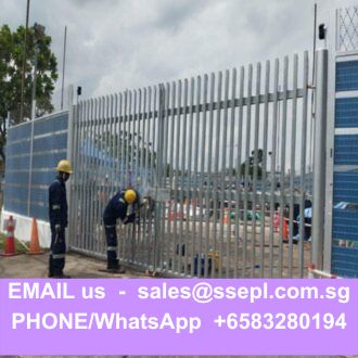 Construction workers in hard hats install a tall metal security gate at a fenced construction site; purple contact banner at the bottom.