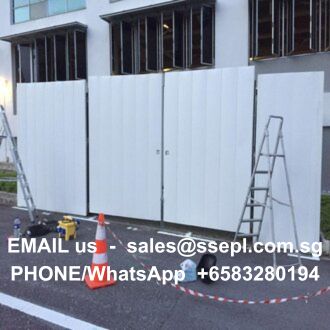 Construction area with white temporary panels, ladders and cones; text on the panels reads 'EMAIL us sales@ssepl.com.sg' and 'PHONE/WhatsApp +65 83280194'