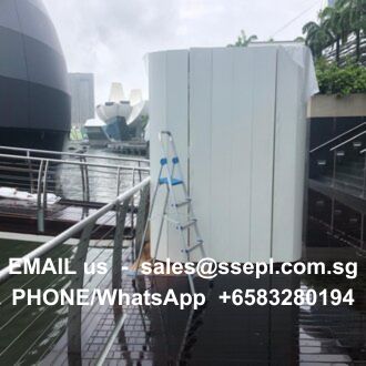 Dockside scene with a white panel and a blue ladder leaning against it; overlaid contact text reads “EMAIL us sales@ssepl.com.sg” and “PHONE/WhatsApp +65 83280194” on a wet deck.